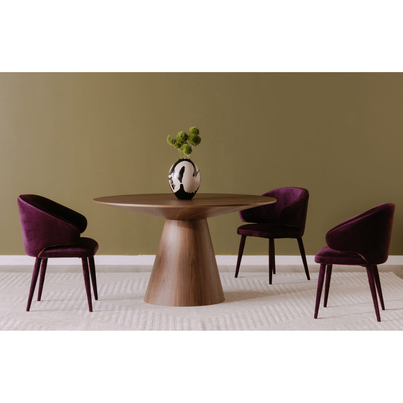 Round walnut dining table with pedestal base and four upholstered chairs