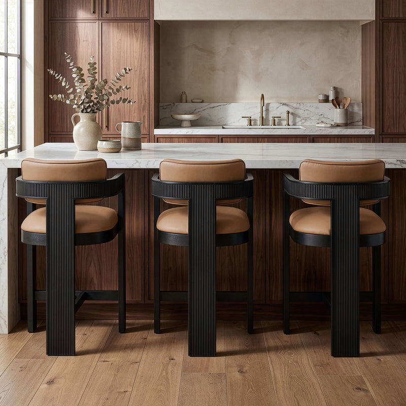Set of 3 vegan leather counter stools with tan upholstered seats and black ribbed bases