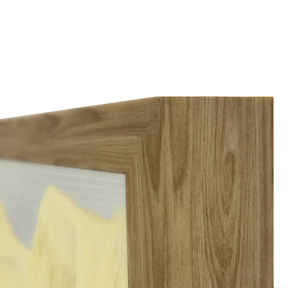 Close-up of light wood frame corner with white and pale yellow paint details