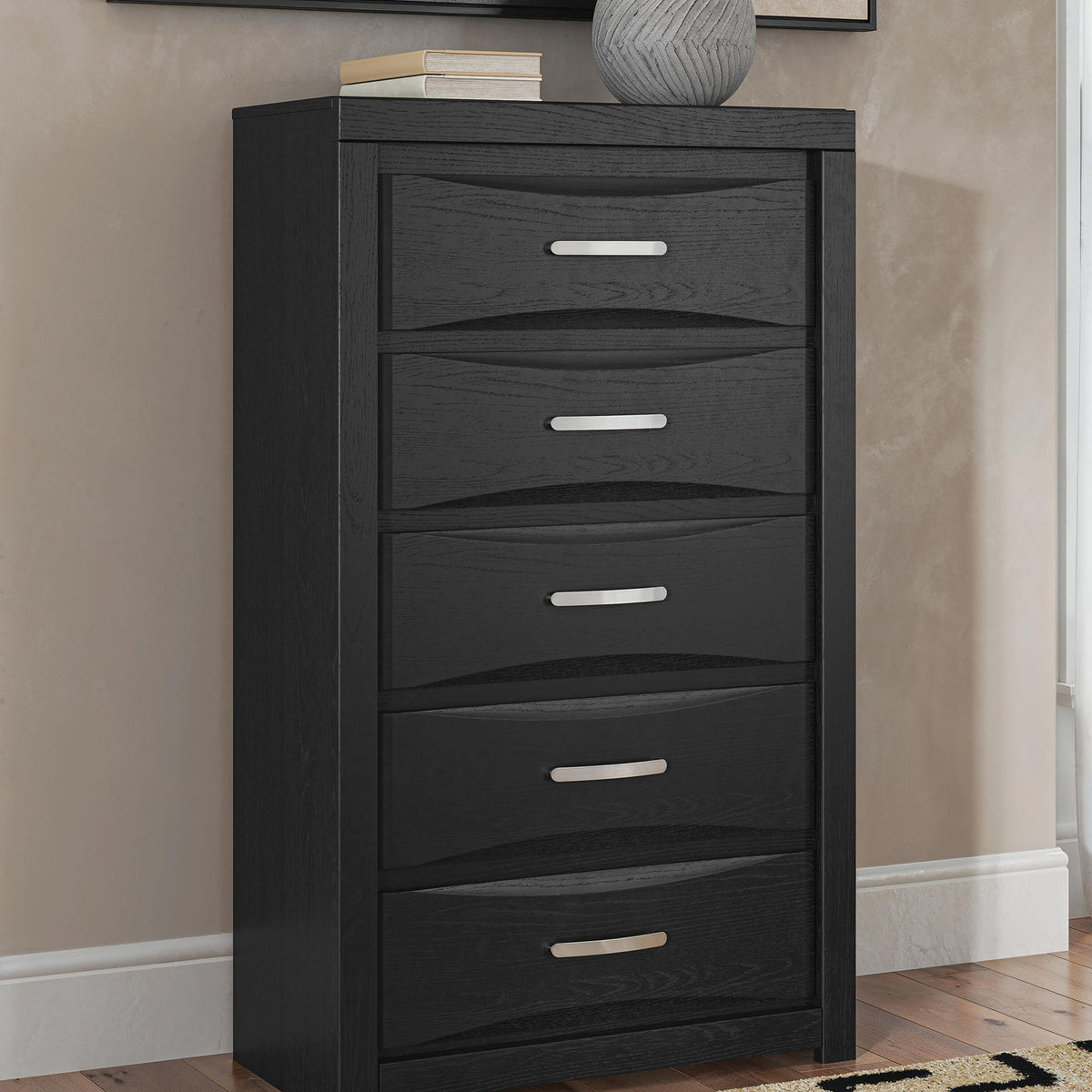 Black five-drawer chest with five front drawers and slim bar handles
