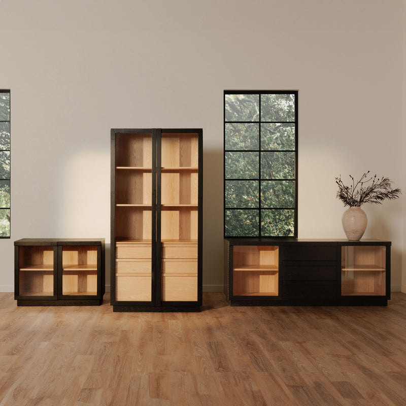 Tall black cabinet with clear doors and interior wood shelves