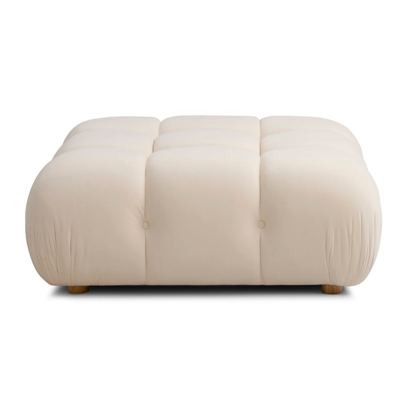 White modular ottoman with three padded sections, button tufting, and short wooden feet