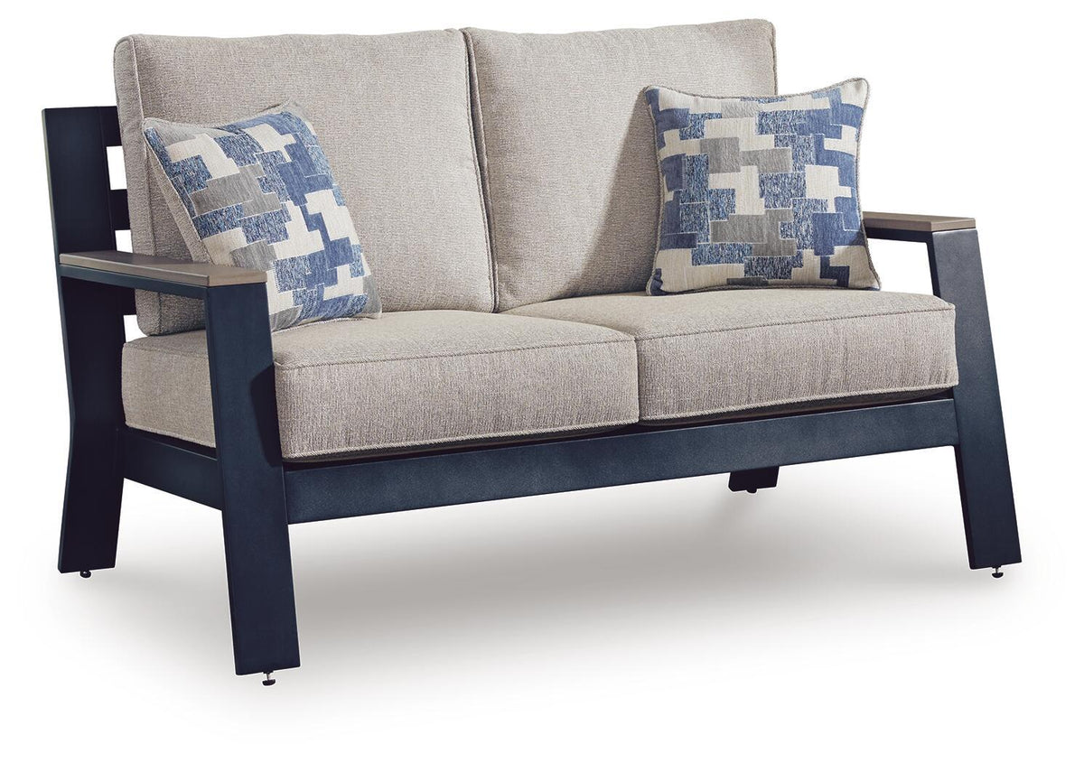 Blue outdoor loveseat with beige cushions and two blue-and-white square throw pillows