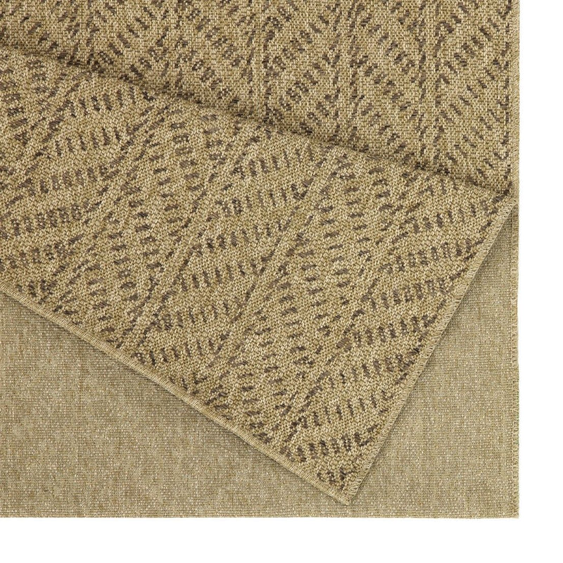 Light brown area rug close-up showing textured chevron weave and bound edge
