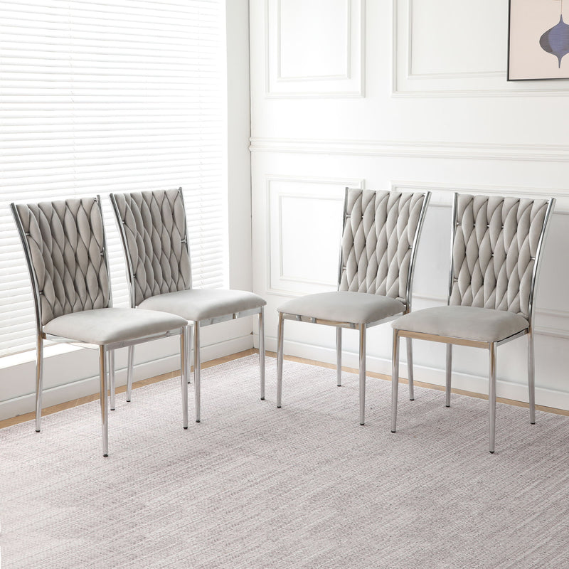 Set of four light gray tufted dining chairs with chrome legs and padded seats