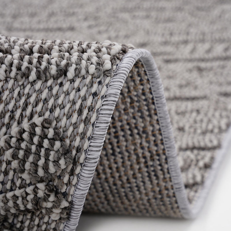 Traditional indoor/outdoor rug, gray woven texture with braided edge and fringe