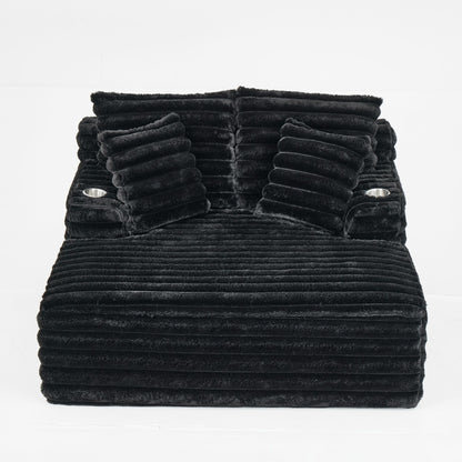 Oversized dark gray chaise lounge chair with ribbed plush upholstery and built-in pillows
