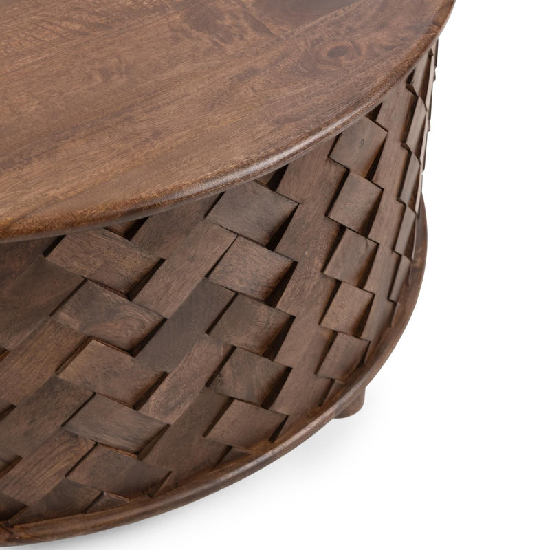 Close-up of woven mango wood side panels on a round dark brown table