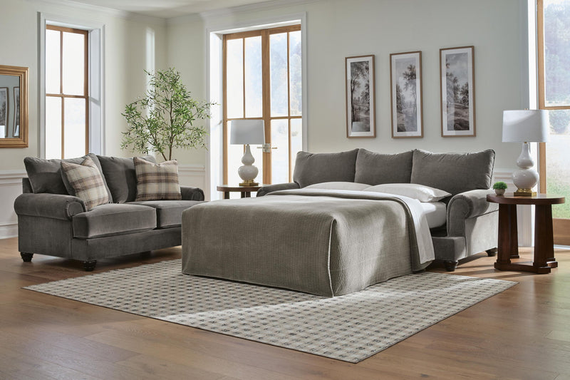 Queen sofa sleeper with open bed platform and dark gray cushions