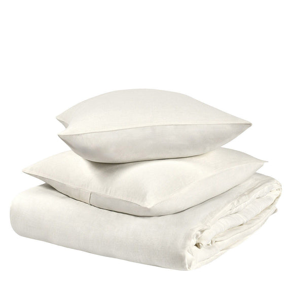 Stacked light ivory hemp duvet and pillow shams with neatly folded corners