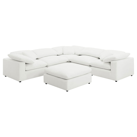White modular sectional sofa with curved arms and matching ottoman chaise