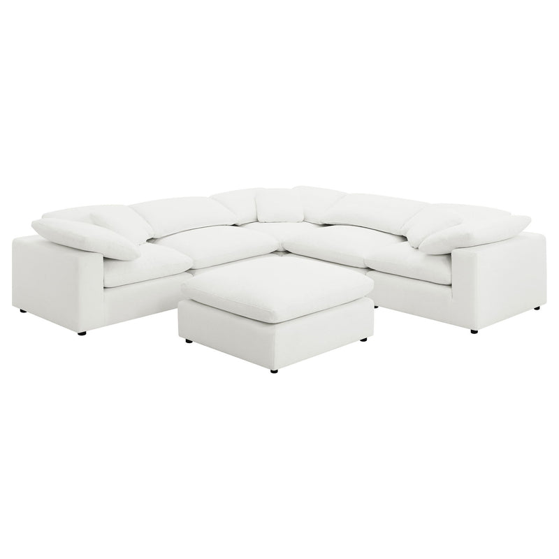 White modular sectional sofa with curved arms and matching ottoman chaise