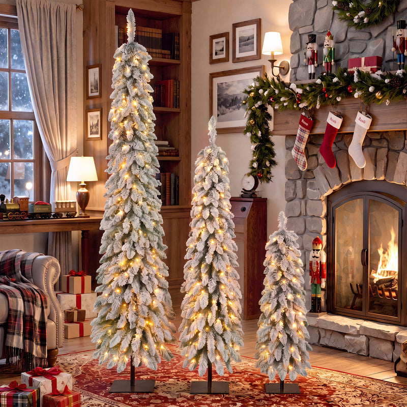 White slim flocked pencil Christmas trees with warm LED lights and black bases