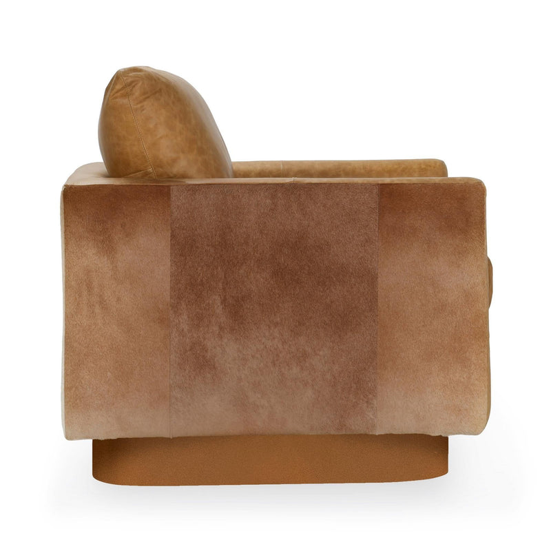 Brown leather accent chair viewed from the side, rounded seat and arms