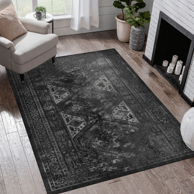 Charcoal gray washable area rug with faded vintage medallion and border pattern