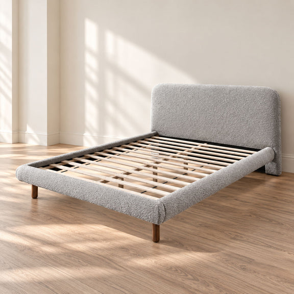 Gray upholstered platform bed with curved headboard, slatted base, and wooden legs
