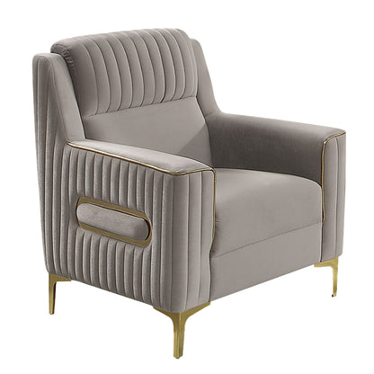 Light gray accent chair with ribbed upholstery, gold piping, and a rectangular front handle detail