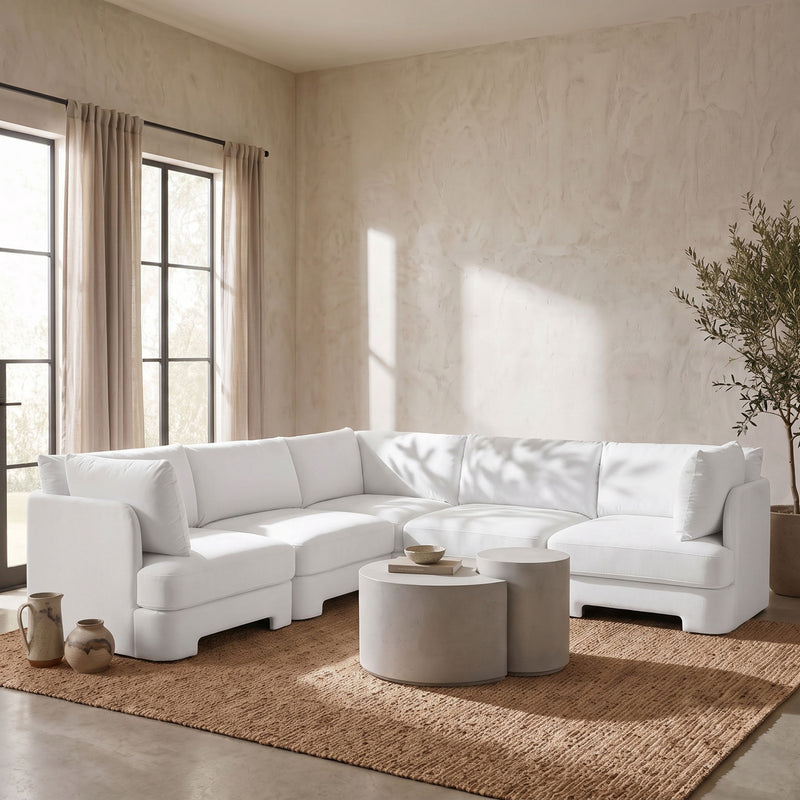 White velvet corner sectional sofa in living room setting with chaise module.