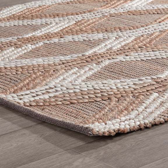 Close-up of natural fiber rug surface with tan and ivory braided stripe texture.