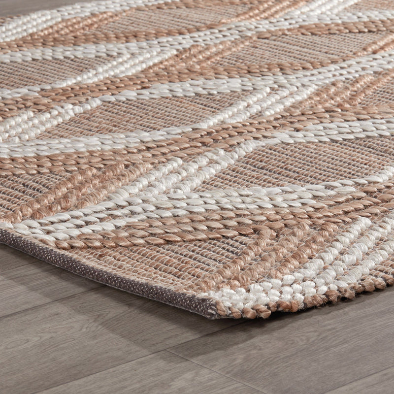 Close-up of natural fiber rug surface with tan and ivory braided stripe texture.