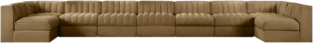 Light brown armless velvet modular sectional with tufted back cushions and curved arm ends
