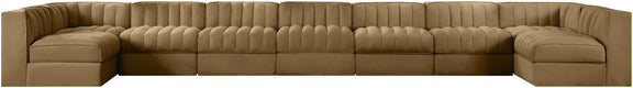 Light brown armless velvet modular sectional with tufted back cushions and curved arm ends
