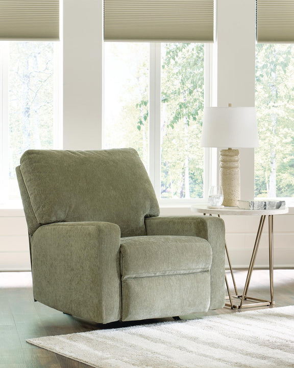 Green rocker recliner chair with padded arms, boxy seat, and recline backrest