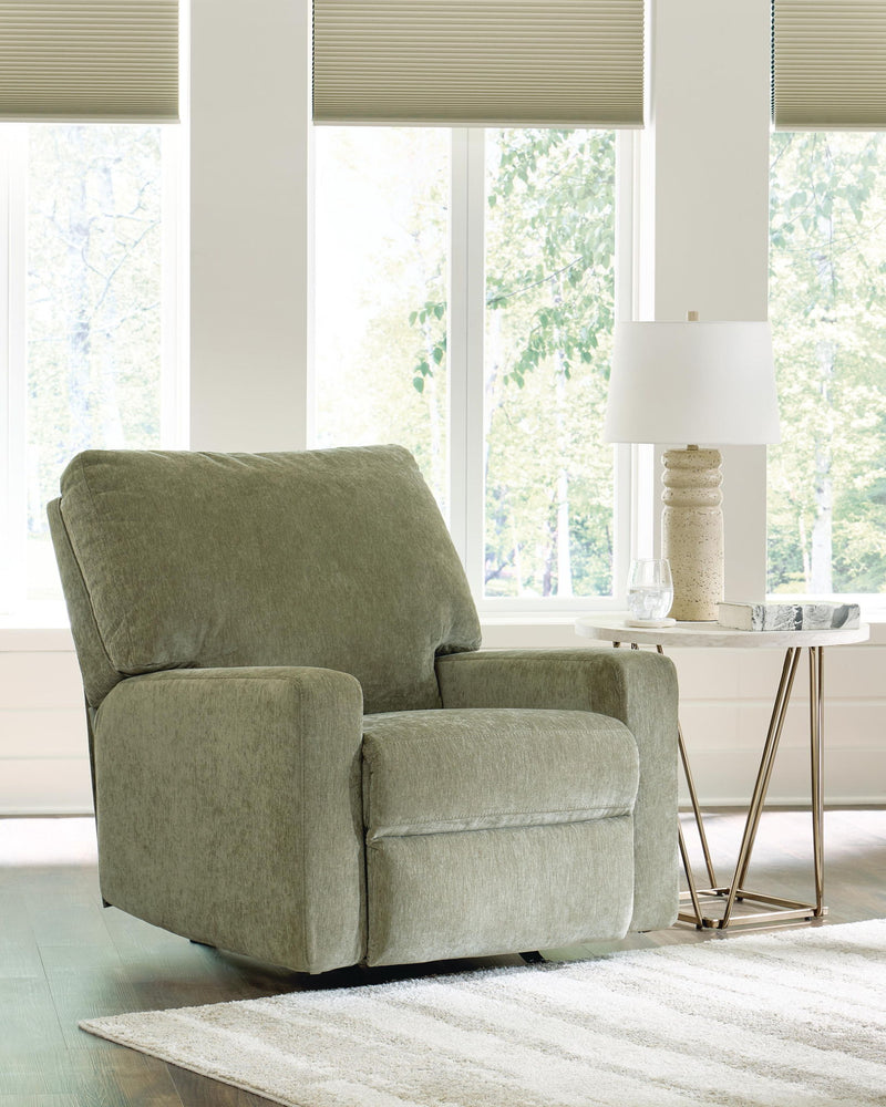 Green rocker recliner chair with padded arms, boxy seat, and recline backrest