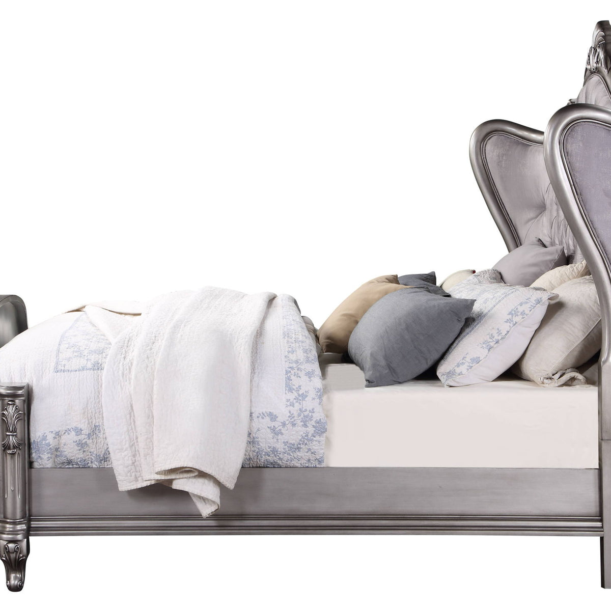 Silver upholstered platform bed with tufted headboard and decorative trim