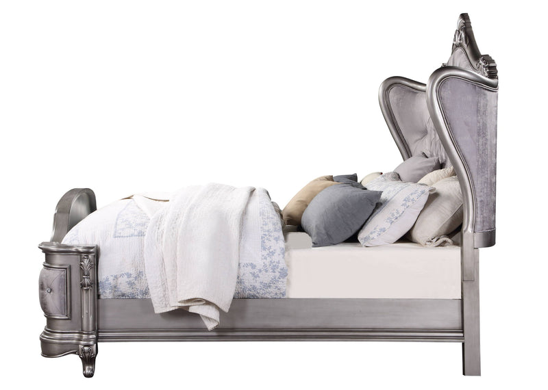 Silver upholstered platform bed with tufted headboard and decorative trim