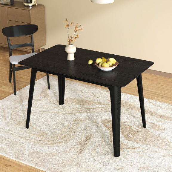 Black dining table with tapered legs and glossy dark wood-look top