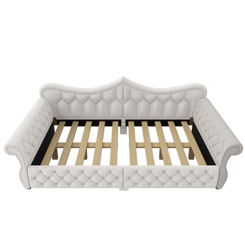 White upholstered daybed with tufted panels and slatted base