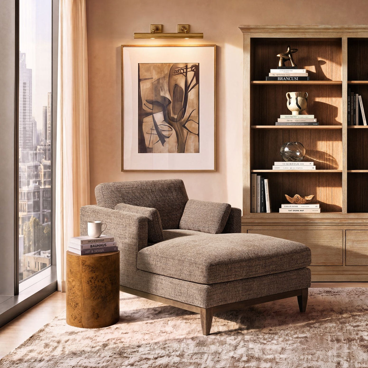 Gray fabric chaise lounge chair with two back pillows and tapered wooden legs
