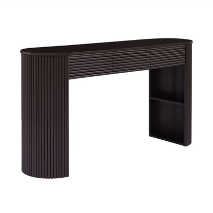 Dark brown console table with ribbed sides, curved top, three drawers and open shelf.