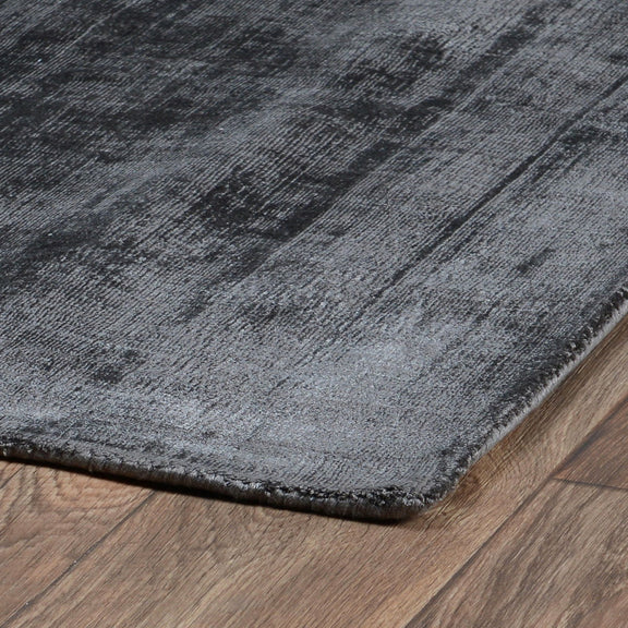 Berlin rug close-up in dark gray with distressed pattern and bound edge