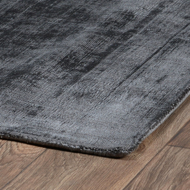 Berlin rug close-up in dark gray with distressed pattern and bound edge