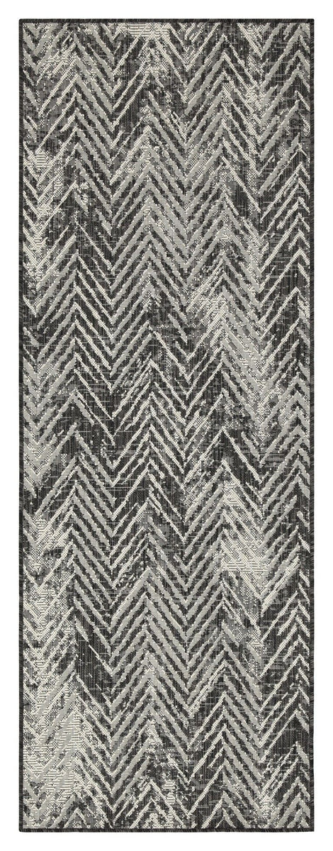 Dark gray indoor/outdoor area rug close-up with light zigzag chevron pattern.
