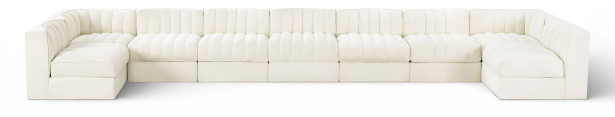 White velvet modular sectional sofa with tufted cushions and curved armrests