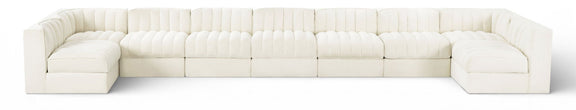White velvet modular sectional sofa with tufted cushions and curved armrests