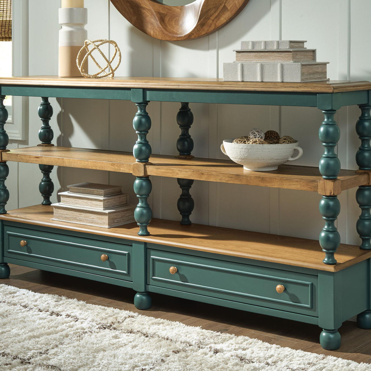 Console table with two shelves and two drawers, light wood surfaces, dark teal finish