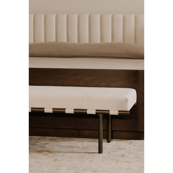 Close view of the beige cushioned bench seat, woven support straps, and dark metal legs