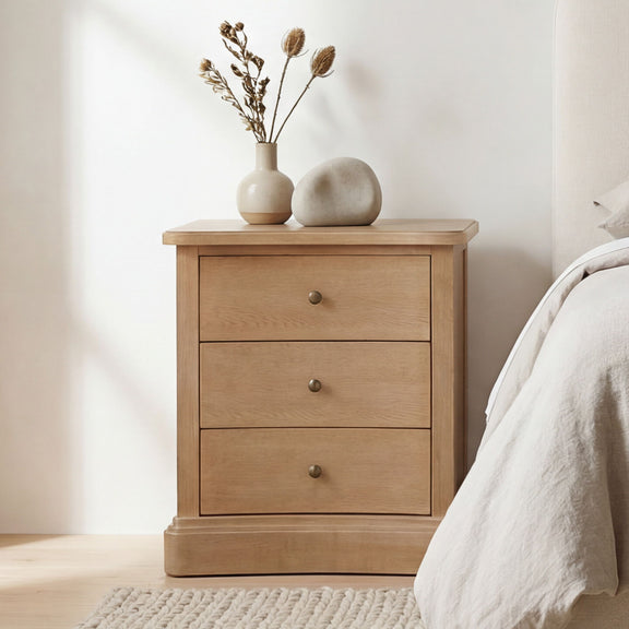 Natural wood nightstand with three drawers and round metal knobs