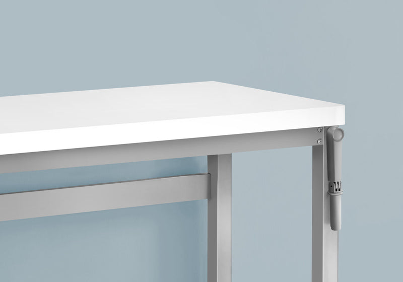 Close-up of height adjustment hardware under white desktop on standing desk