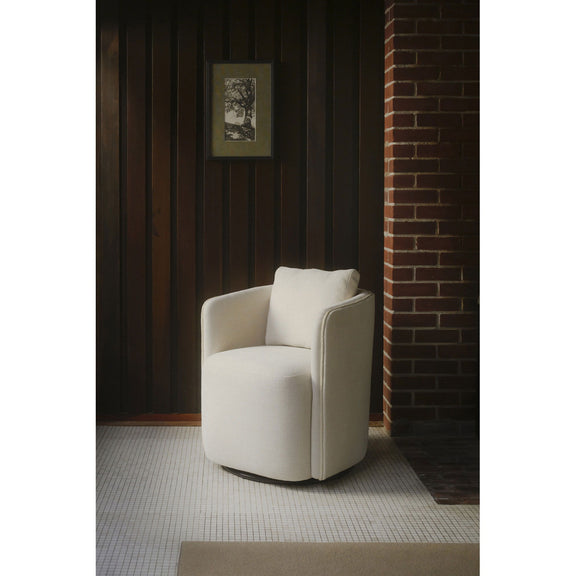 Warm white upholstered dining chair viewed from the side with cushioned arms