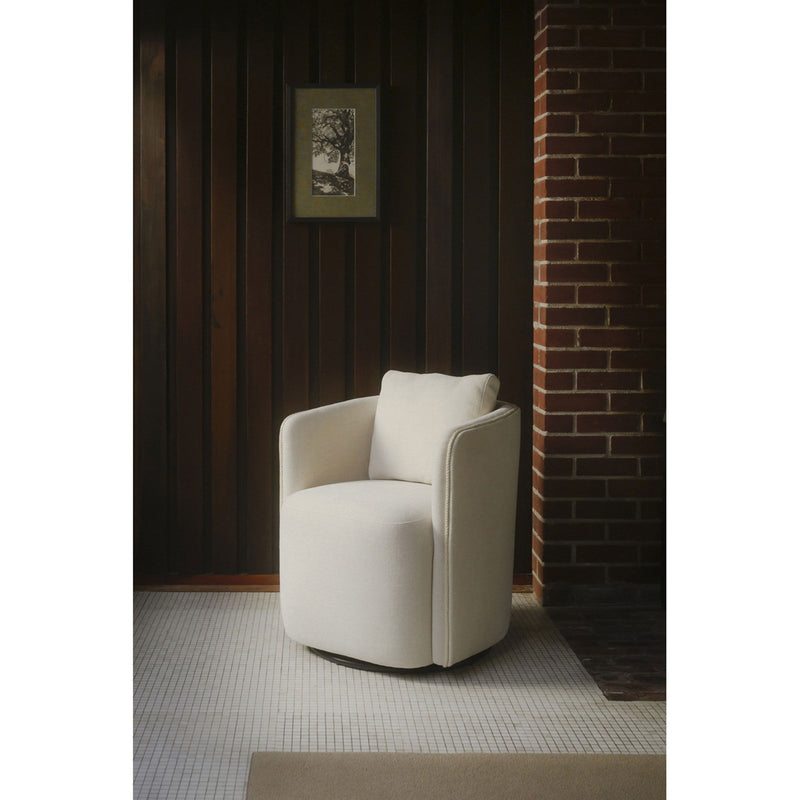 Warm white upholstered dining chair viewed from the side with cushioned arms