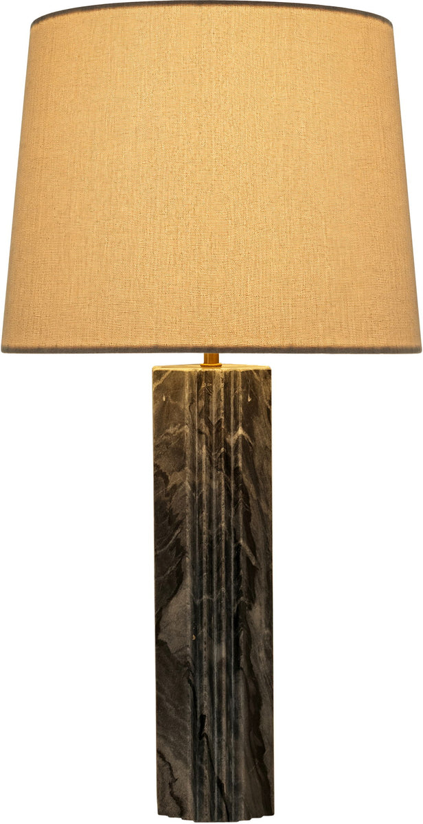 Table lamp with tan fabric shade and dark marbled stone column base