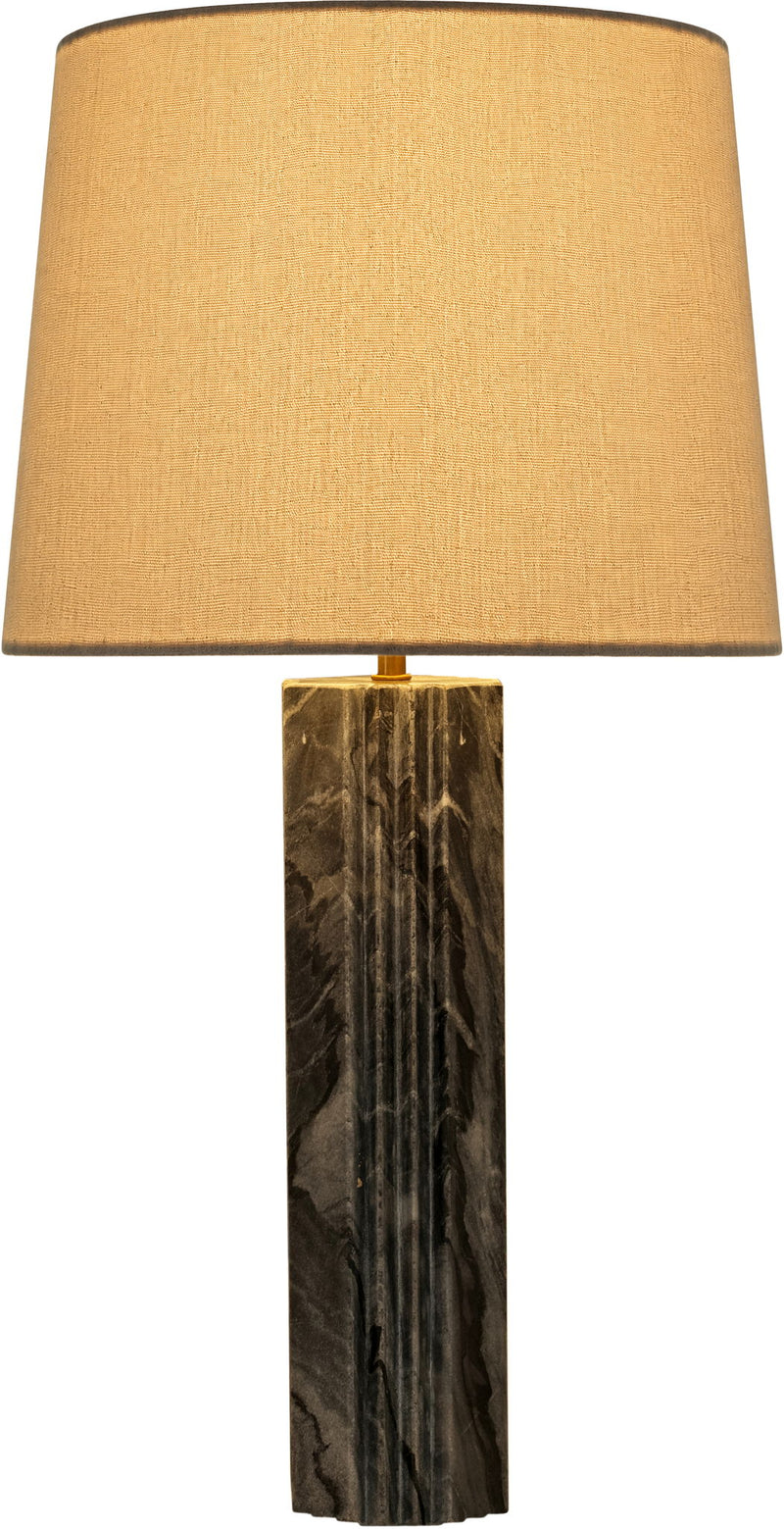 Table lamp with tan fabric shade and dark marbled stone column base