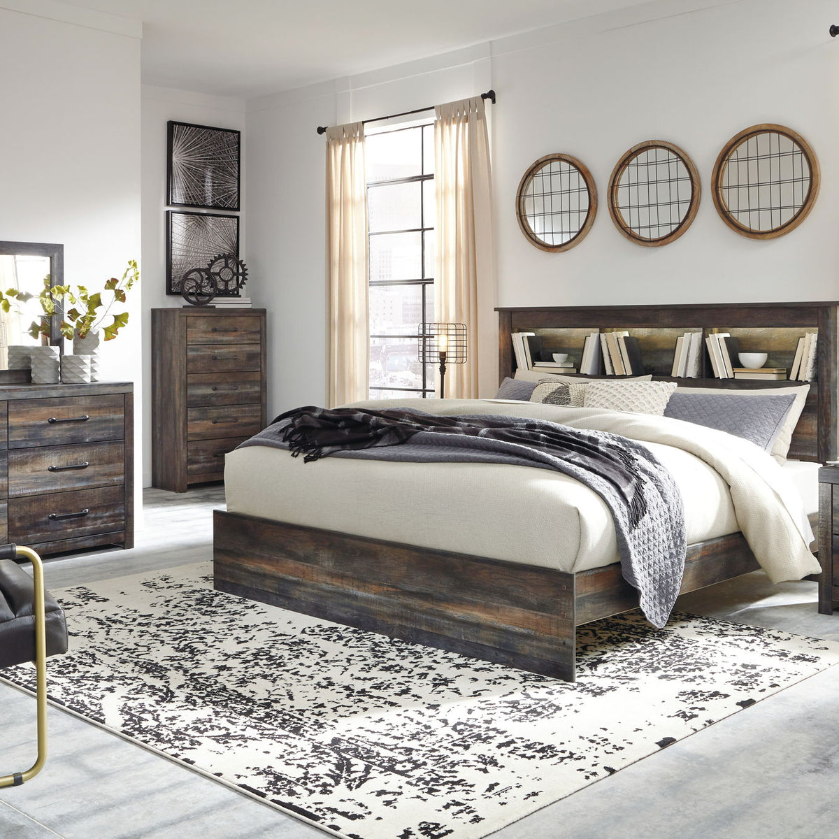 Panel bookcase bed in dark wood with two drawers and bookcase headboard, layered bedding