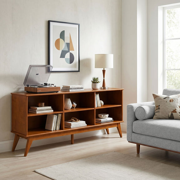 Medium wood low bookcase with open shelves and tapered legs, styled with decor