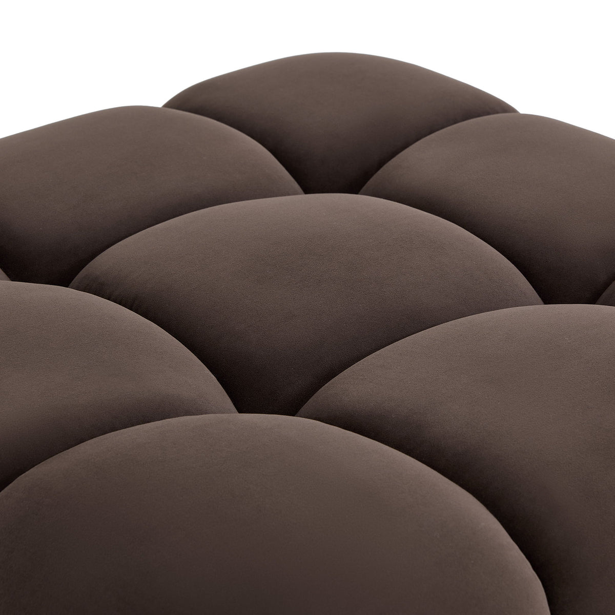 Dark brown chair upholstery close-up with rounded tufted cushion seams